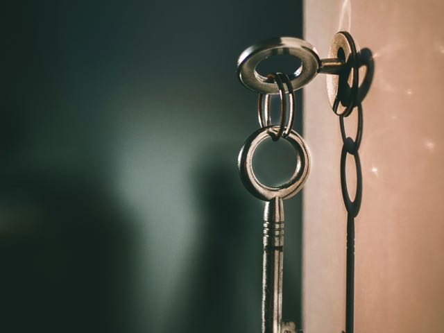A key on a ring sitting in a door lock
